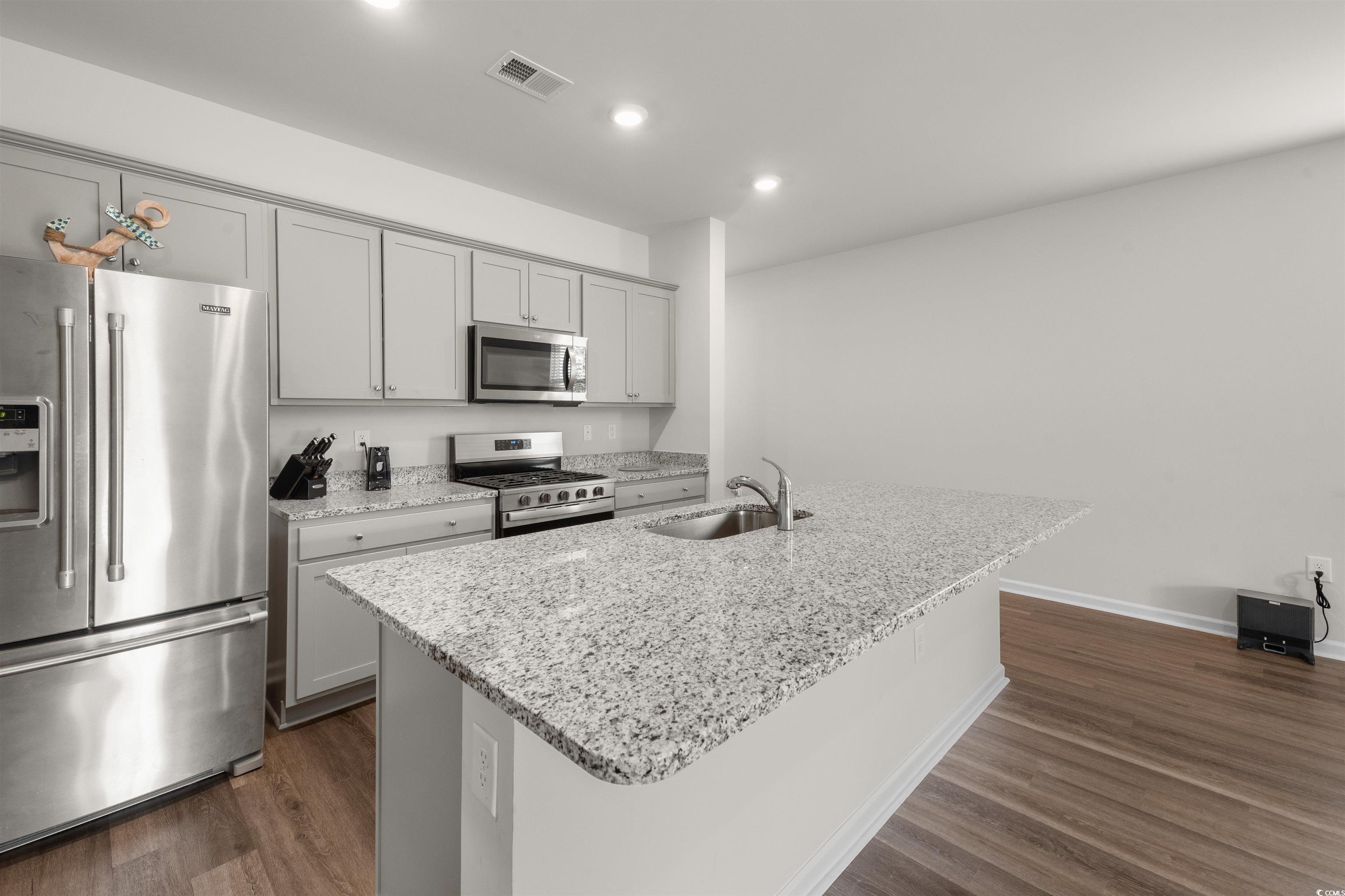 3119 Fair Rdg Way Conway, SC 29526 - Photo 8 of 38 Kitchen featuring appliances with stainless steel finishes, dark wood-style flooring, gray cabinetry, recessed lighting, and light stone counters