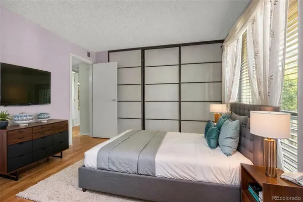 a bedroom with a bed and a flat screen tv