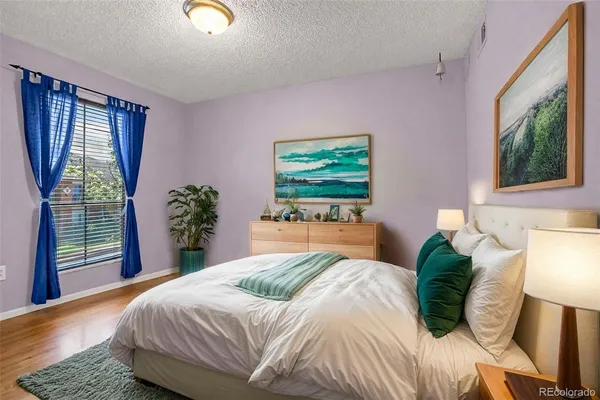 a bedroom with a large bed and a window