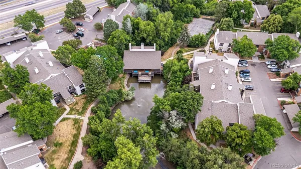 an aerial view of a house with a yard and lake view