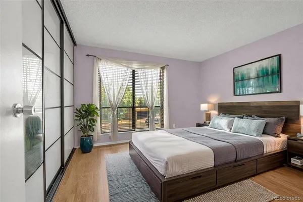 a bedroom with a large bed and a chandelier