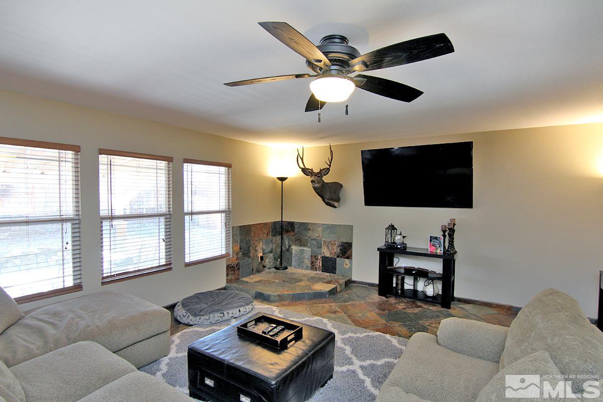 7762 Welsh Drive Reno, NV 89506 - Photo 8 of 25 a living room with furniture and a flat screen tv