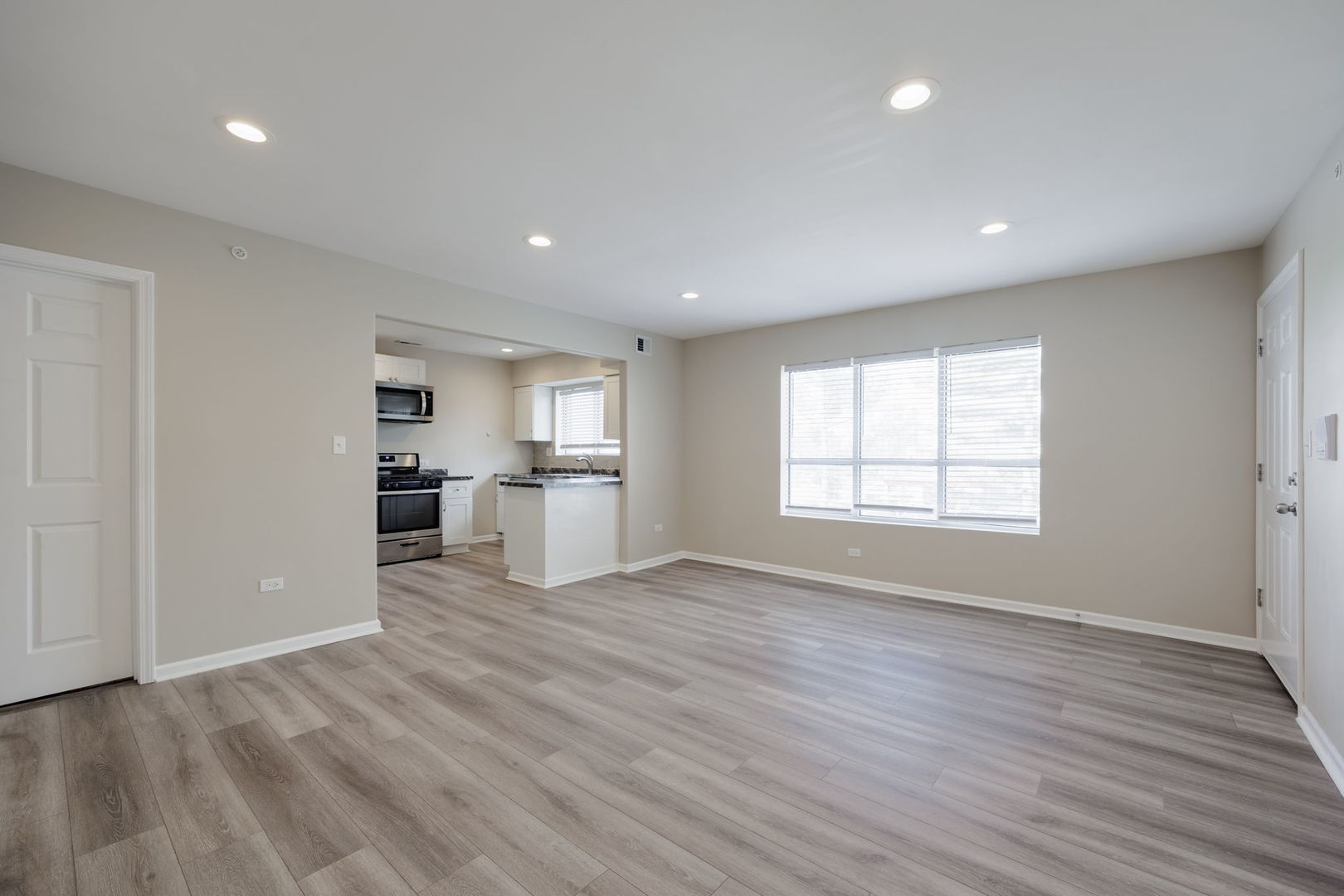 11933 South Pulaski Road, Unit 2 Alsip, IL 60803 - Photo 3 of 11 a view of a kitchen with wooden floor and windows