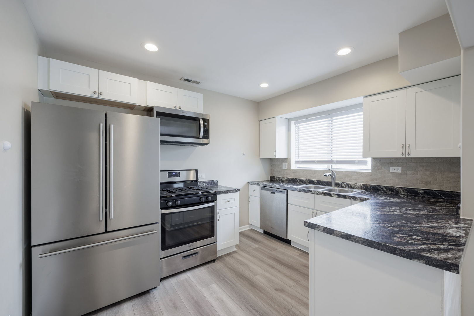 11933 South Pulaski Road, Unit 2 Alsip, IL 60803 - Photo 4 of 11 a kitchen with stainless steel appliances granite countertop a refrigerator stove and sink
