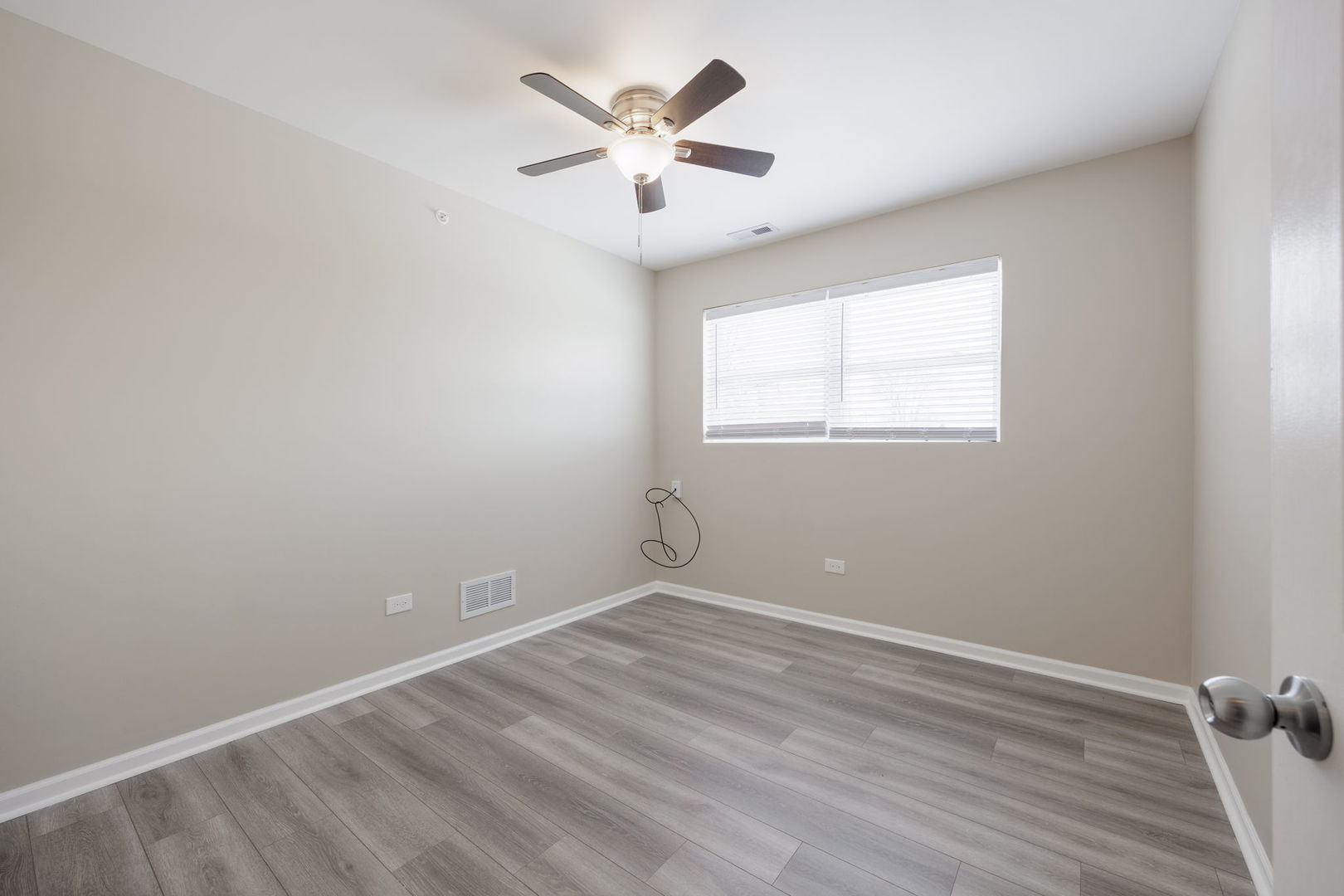 11933 South Pulaski Road, Unit 2 Alsip, IL 60803 - Photo 7 of 11 an empty room with windows and ceiling fan
