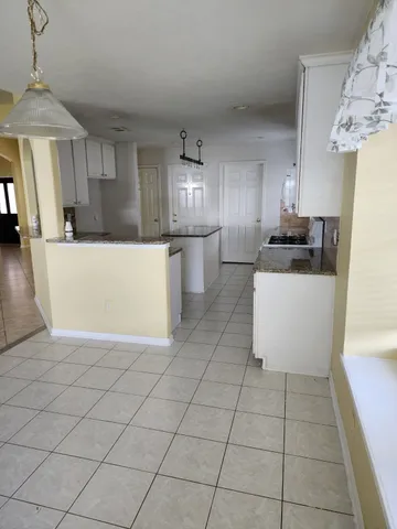 a kitchen with stainless steel appliances a refrigerator sink and microwave