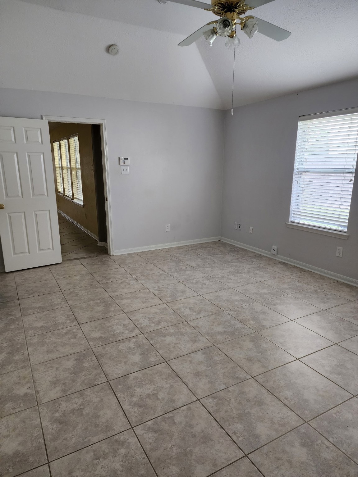 2314 Hannover Way Spring, TX 77388 - Photo 9 of 11 an empty room with a ceiling fan and windows