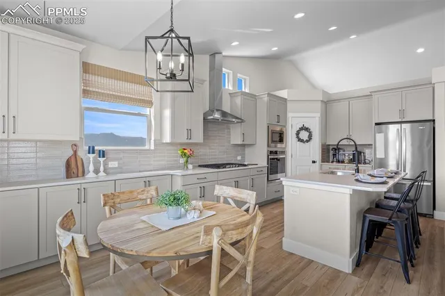a kitchen with stainless steel appliances kitchen island granite countertop a sink and cabinets