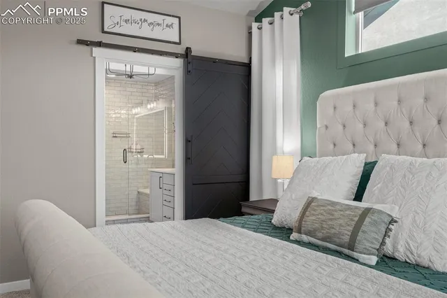 a bedroom with a bed and a refrigerator