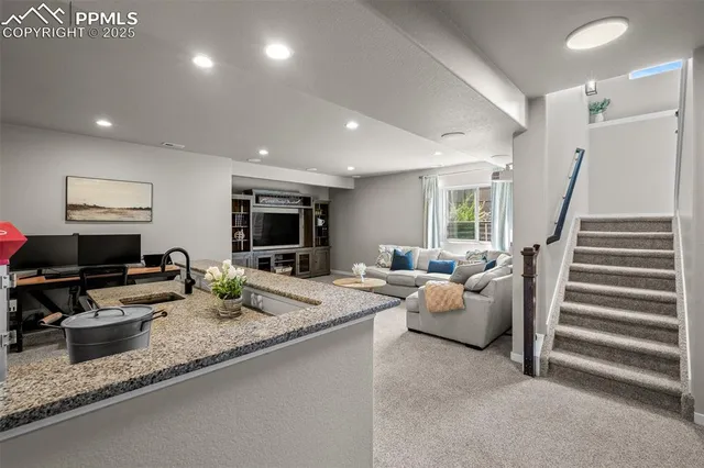 a living room with furniture and flat screen tv