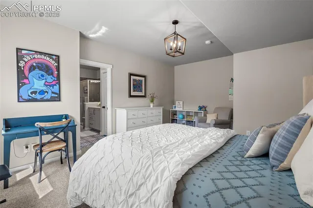 a bedroom with bed and a chandelier