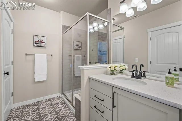 a bathroom with a double vanity sink mirror and shower