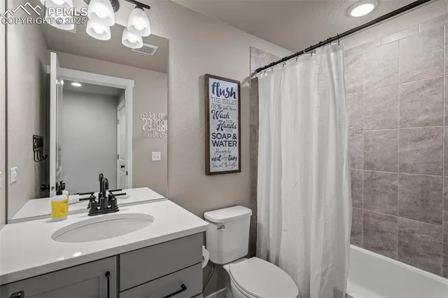 a bathroom with a sink vanity mirror and toilet