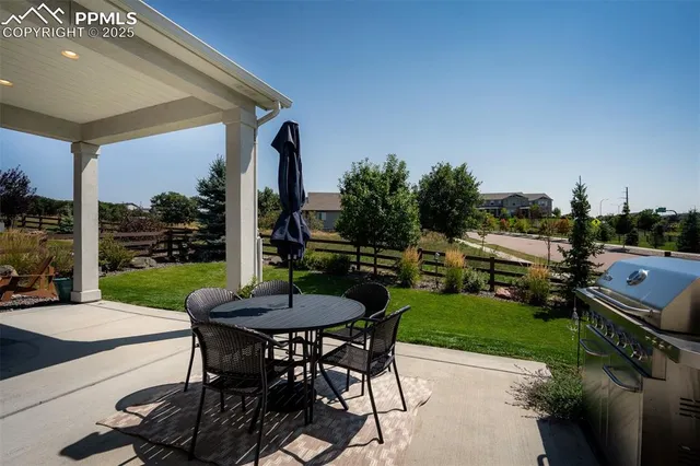 a view of a backyard with sitting area furniture and garden