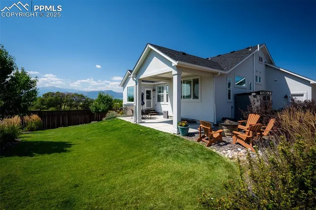a backyard of a house with yard and outdoor seating