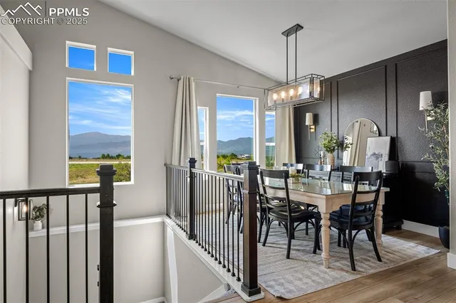 a view of a dining room with furniture window and wooden floor
