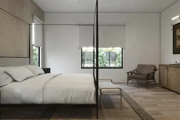 a bedroom with a bed and a chair
