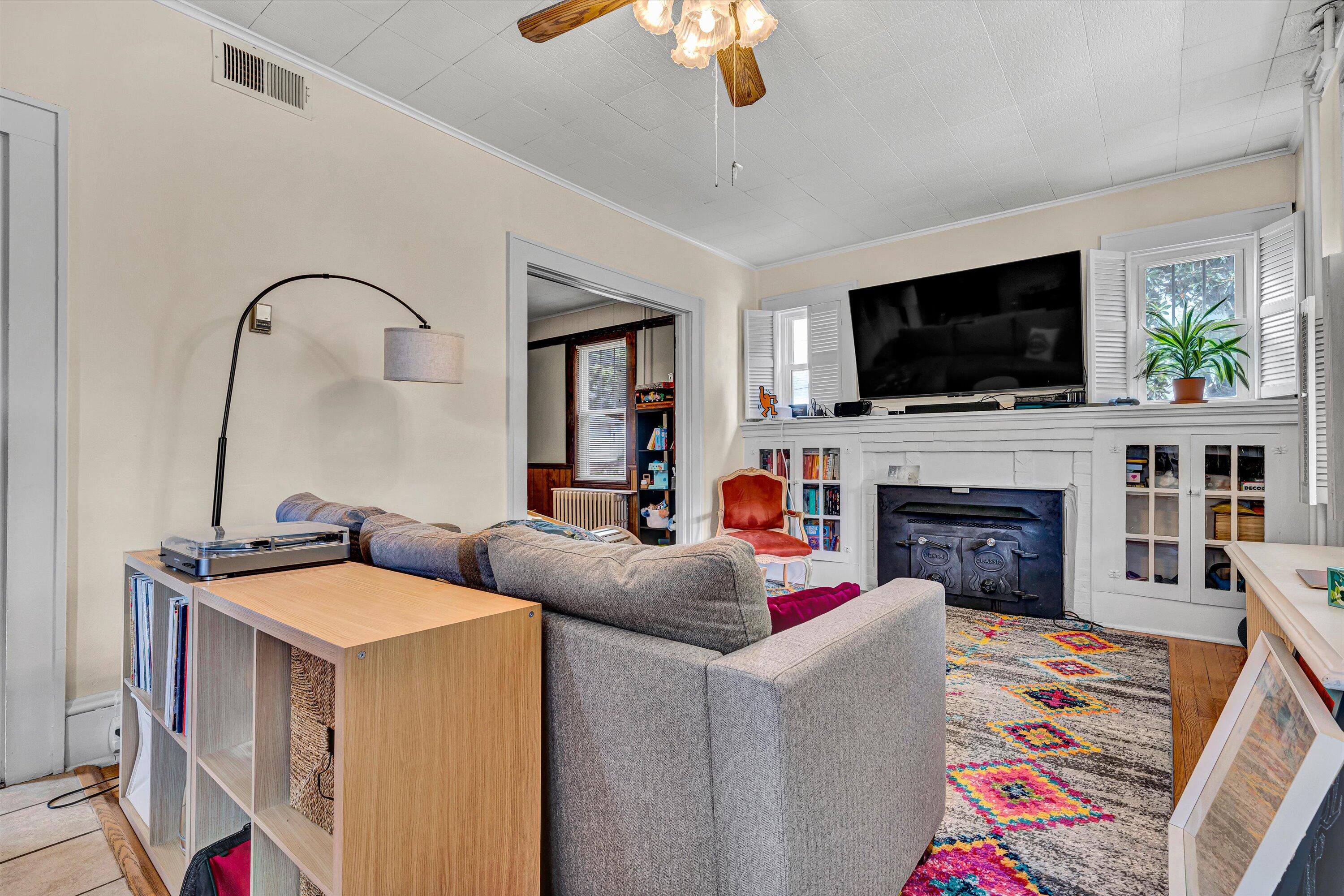 1907 Canterbury Road Southwest Roanoke, VA 24015 - Photo 4 of 36 a living room with fireplace furniture and a flat screen tv