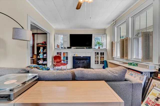 a living room with furniture fireplace and flat screen tv