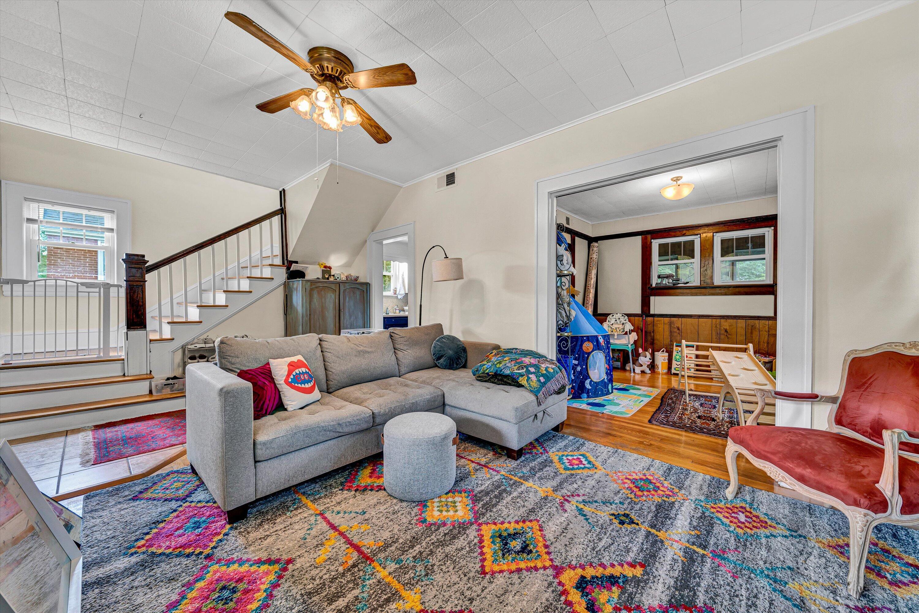 1907 Canterbury Road Southwest Roanoke, VA 24015 - Photo 6 of 36 a living room with furniture a rug and a chandelier