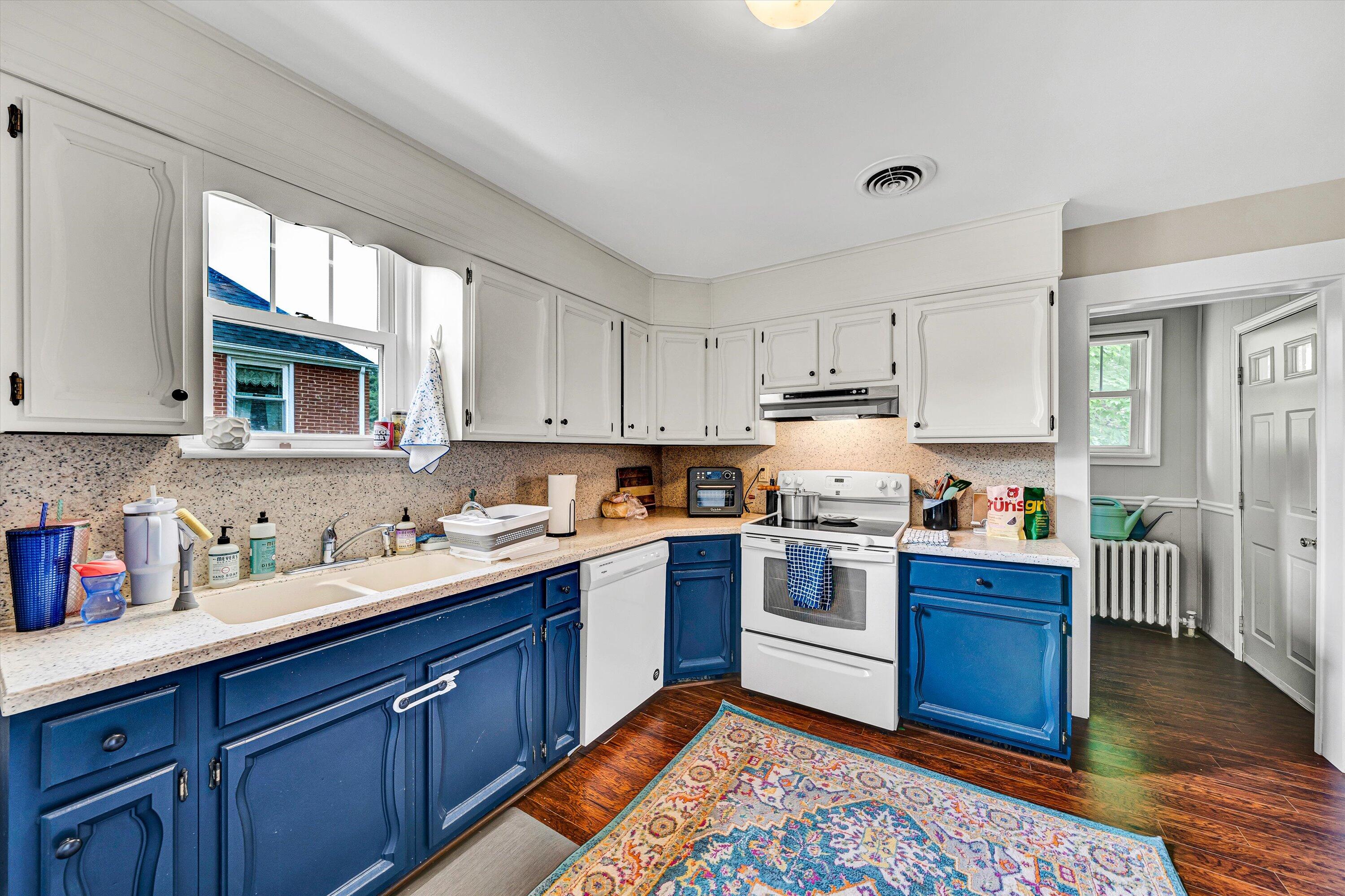 1907 Canterbury Road Southwest Roanoke, VA 24015 - Photo 10 of 36 a kitchen with stainless steel appliances granite countertop a stove a sink dishwasher and a microwave oven with wooden cabinets
