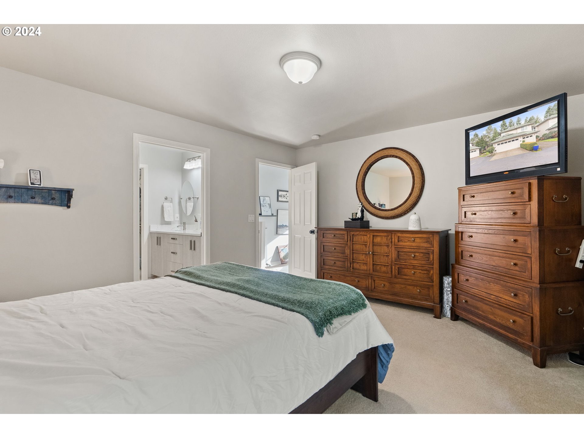 22225 Chelan Loop West Linn, OR 97068 - Photo 45 of 46 a bedroom with a bed and a chandelier