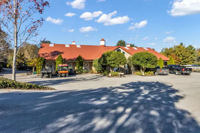 a view of a living room and kitchen with furniture wooden floor and windows