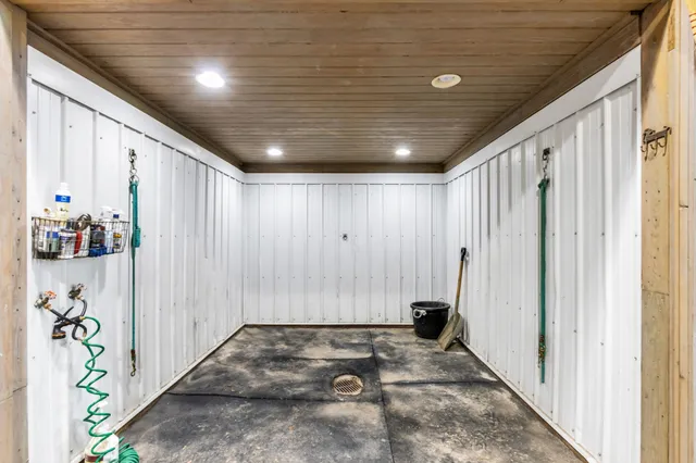 an empty room with windows and chandelier