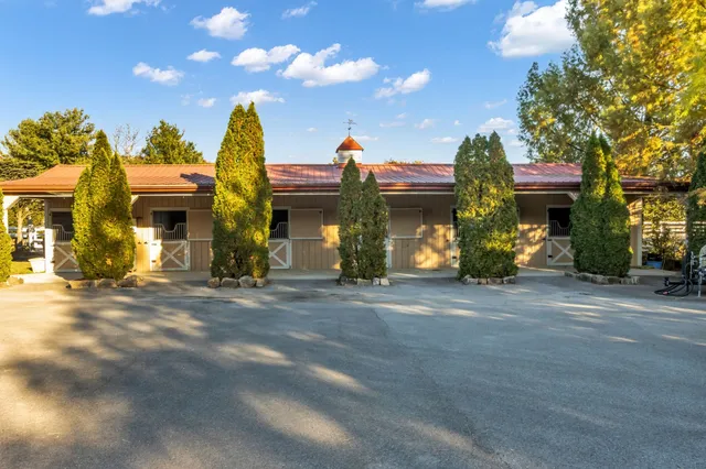 a kitchen with white cabinets and sink