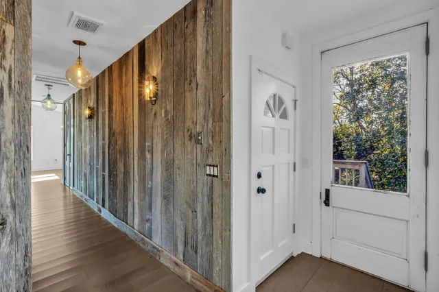 a backyard of a house with lots of plants and tree