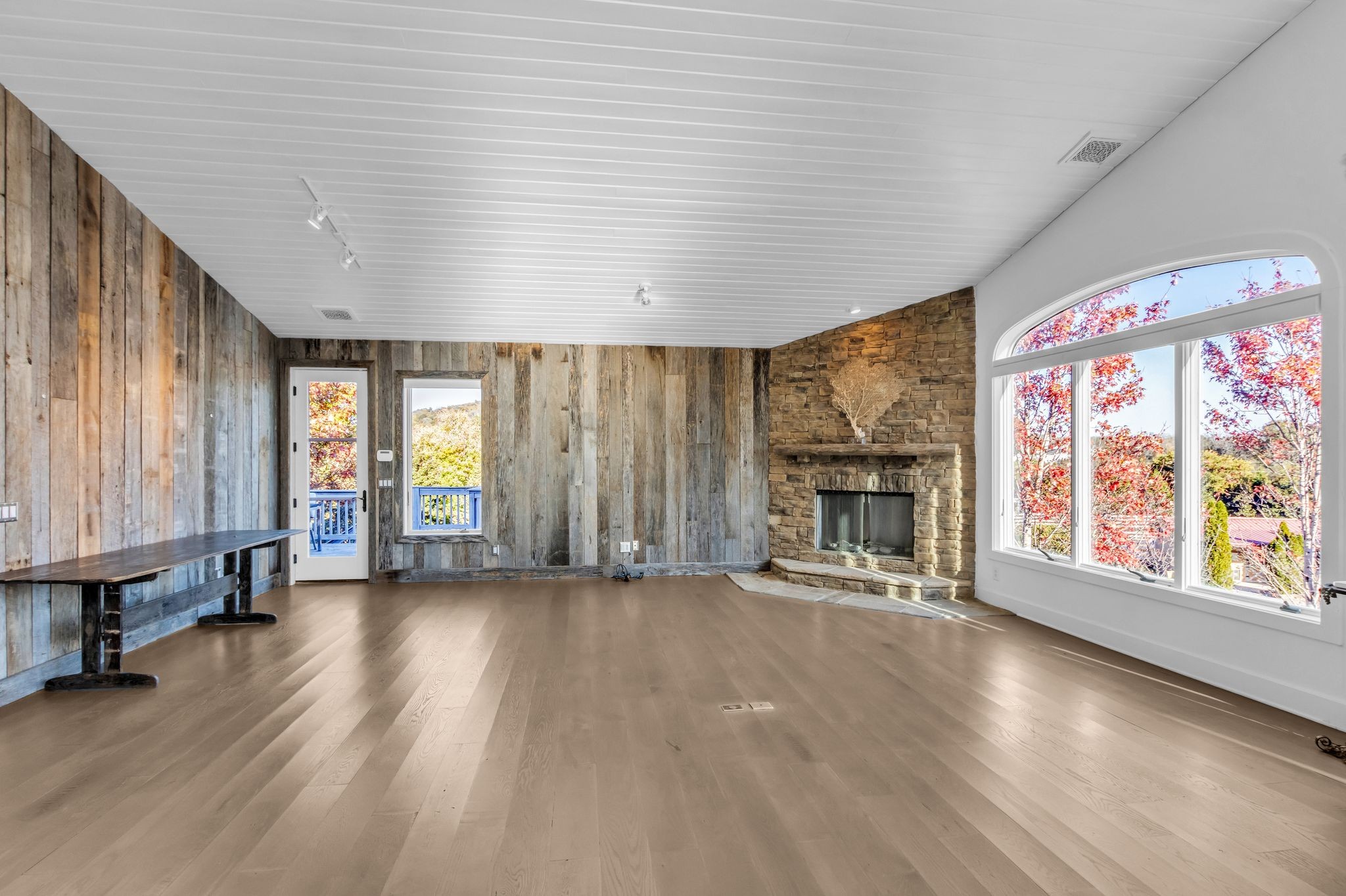 2942 Spanntown Road Arrington, TN 37014 - Photo 43 of 94 an empty room with windows a fireplace and wooden floor