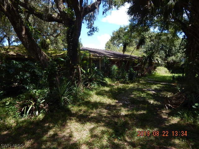 31600 Bermont Road Punta Gorda, FL 33982 - Photo 1 of 23 a backyard of a house with lots of green space