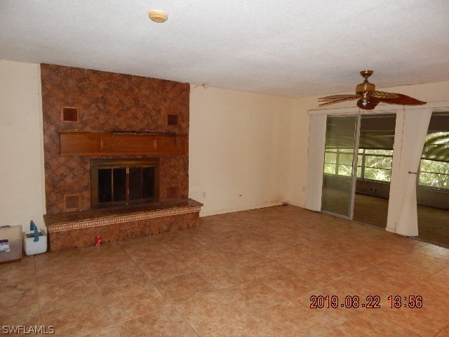 31600 Bermont Road Punta Gorda, FL 33982 - Photo 4 of 23 an empty room with windows and fireplace