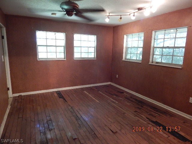 31600 Bermont Road Punta Gorda, FL 33982 - Photo 8 of 23 wooden floor in an empty room with a window