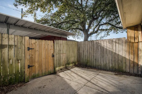 a backyard of a house with a tree