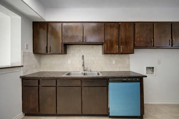 a kitchen with a sink and cabinets