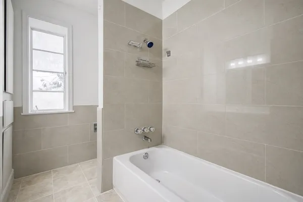 a white bath tub sitting next to a window