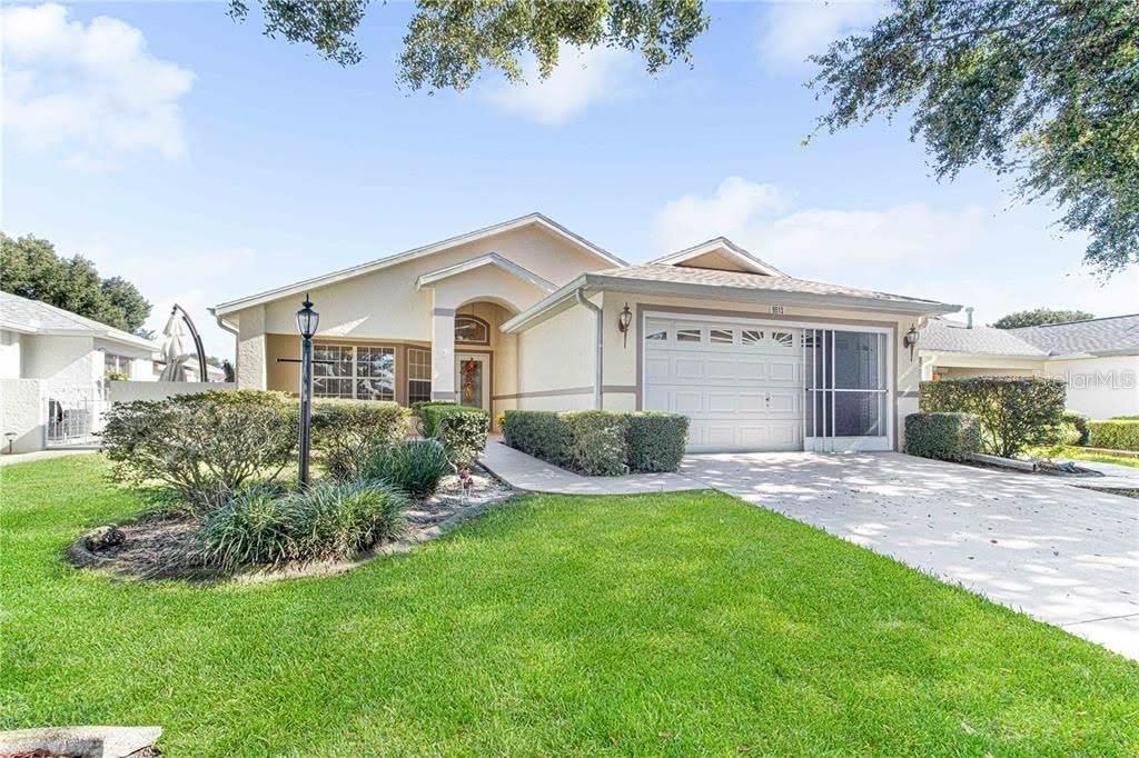 a front view of a house with a garden and yard