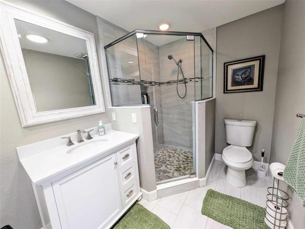 9513 Southwest 92nd Place Road Ocala, FL 34481 - Photo 14 of 16 a bathroom with a sink toilet and shower