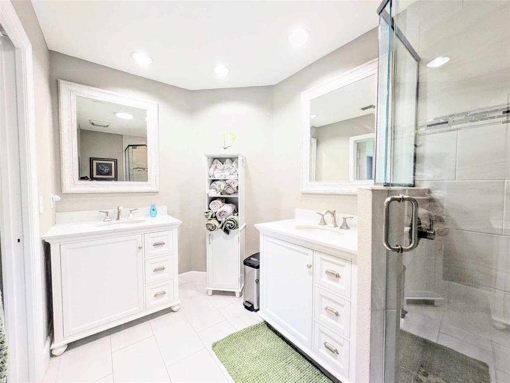 9513 Southwest 92nd Place Road Ocala, FL 34481 - Photo 15 of 16 a bathroom with a sink a mirror and shower
