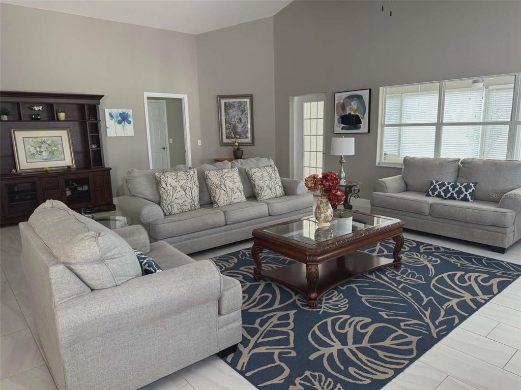 9513 Southwest 92nd Place Road Ocala, FL 34481 - Photo 8 of 16 a living room with furniture and a large window