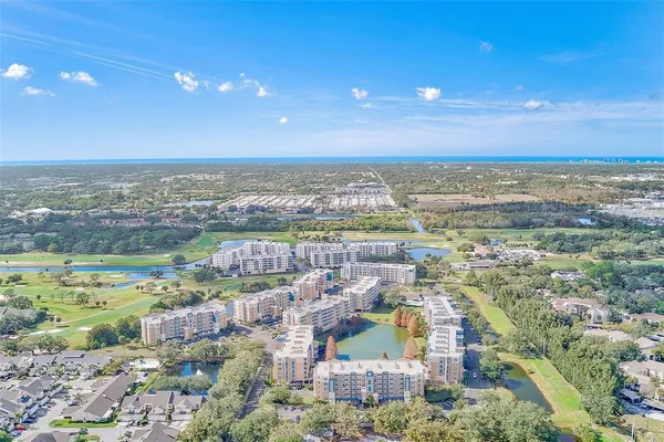 an aerial view of residential houses with outdoor space and river