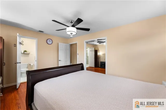 a bedroom with a large bed and a chandelier