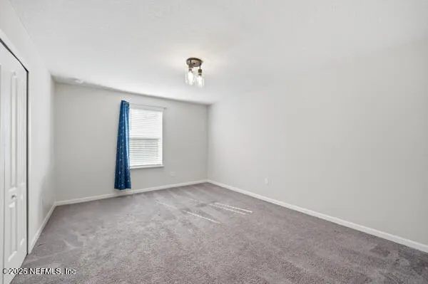 an empty room with windows and wooden floor