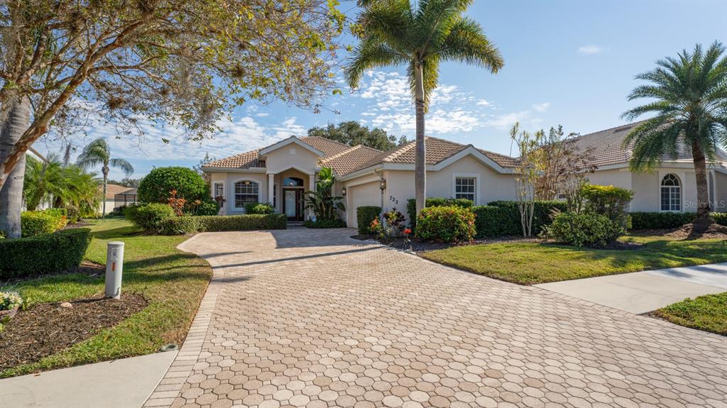 722 Fordingbridge Way Osprey, FL 34229 - Photo 1 of 1 a view of a white house with a yard plants and palm trees