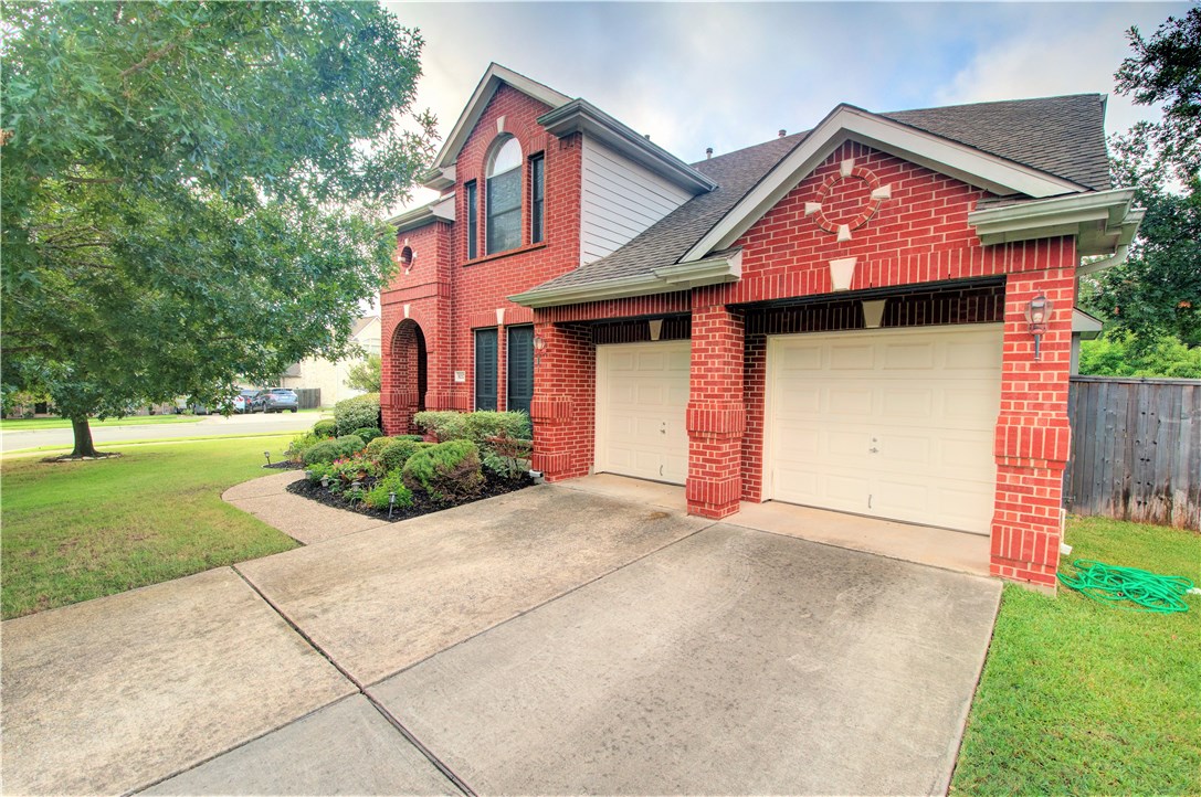 8217 Endeavor Circle Austin, TX 78726 - Photo 3 of 36 a front view of a house with a yard and garage