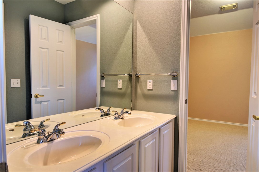 8217 Endeavor Circle Austin, TX 78726 - Photo 32 of 36 a bathroom with a sink and a mirror