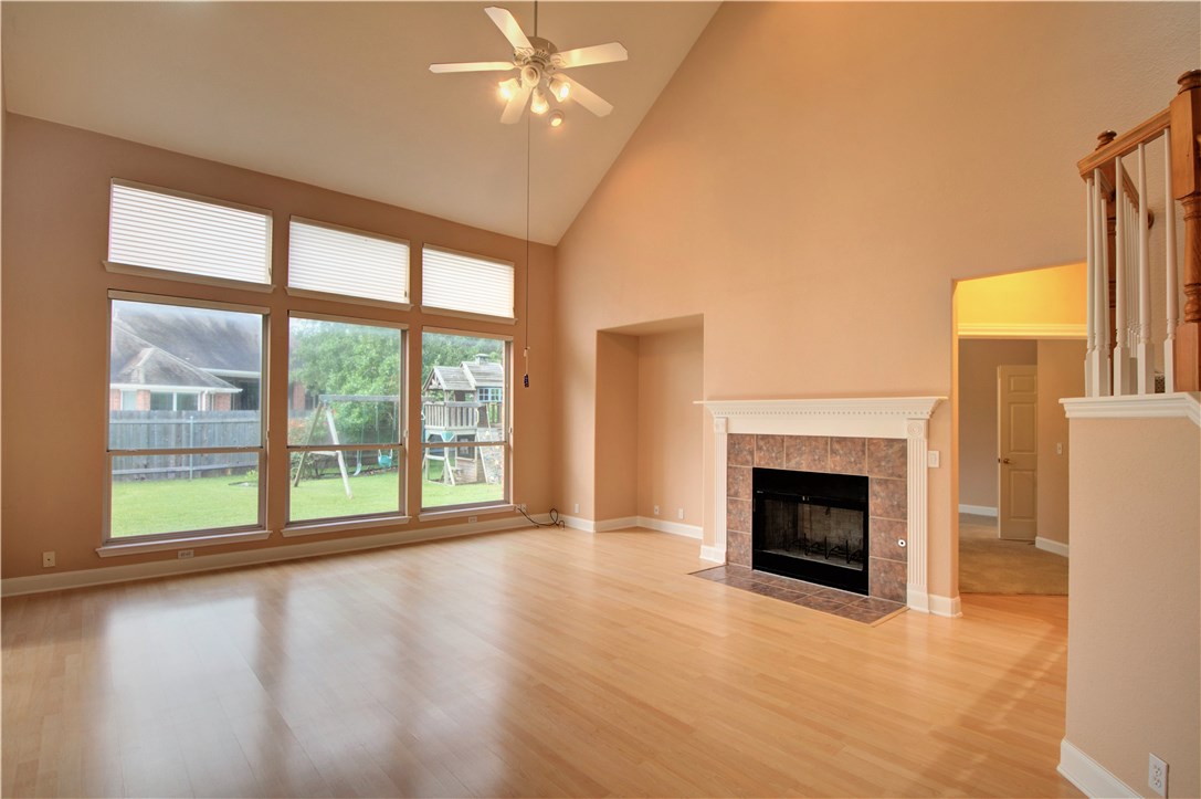 8217 Endeavor Circle Austin, TX 78726 - Photo 8 of 36 a view of an empty room with a fireplace and a window