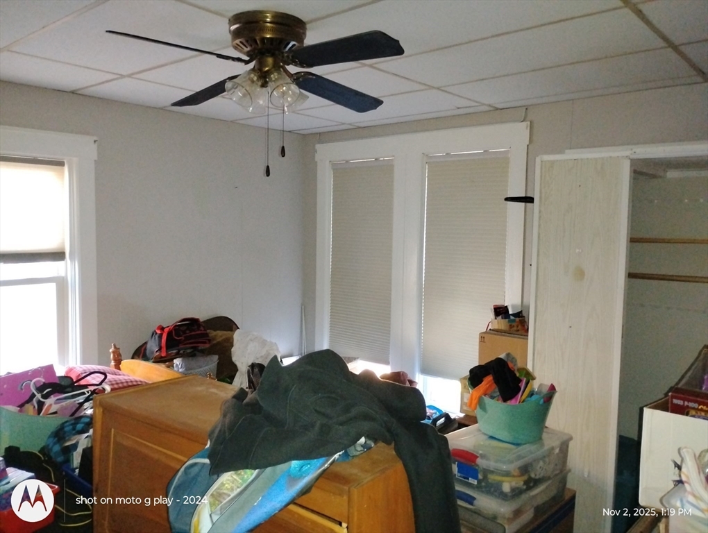 77 West Main Street Ware, MA 01082 - Photo 15 of 17 a bedroom with a bed and a chandelier fan