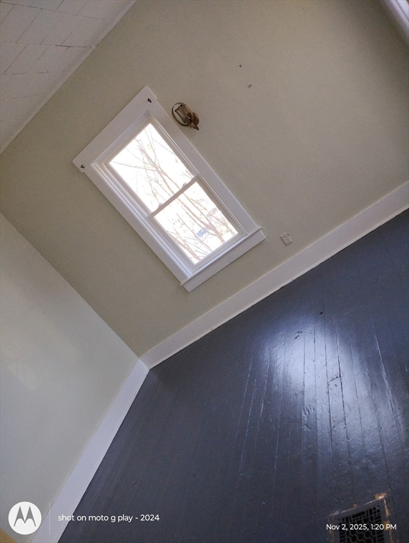 77 West Main Street Ware, MA 01082 - Photo 7 of 17 an empty room with wooden floor and windows